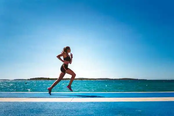 Woman running showing strong leg muscle Westwood